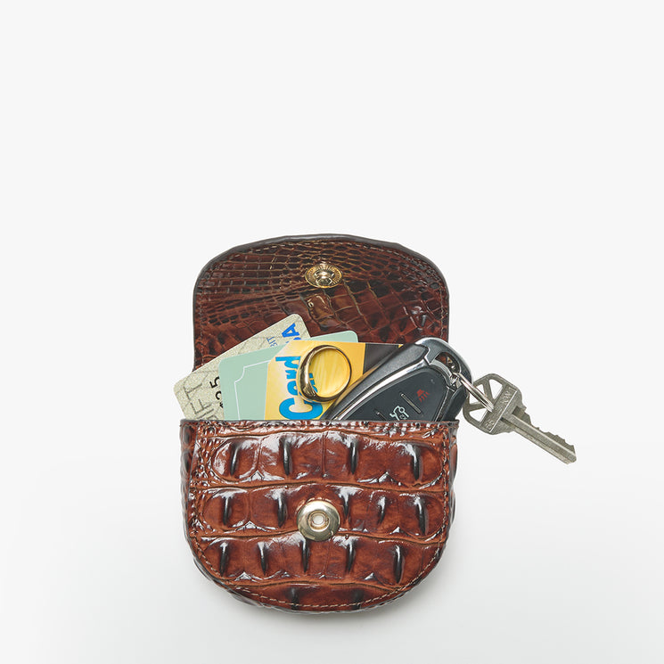 A brown crocodile-embossed leather key case with a snap button closure, shown open with a car key fob, keys, and cards inserted. The product is photographed on a clean, solid white background.
