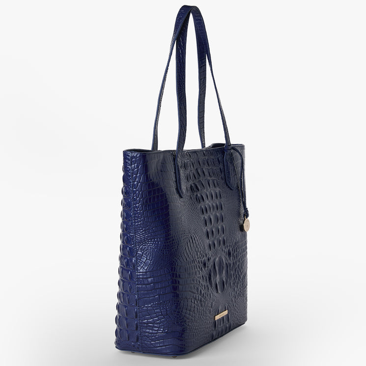 Brahmin Laurel Midnight Blue Melbourne tote in embossed leather with dual shoulder straps, gold-tone logo charm, and front gold bar detail. The structured bag is shown against a white background.