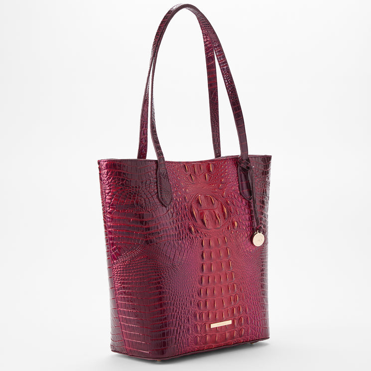 BRAHMIN Laurel Ruby Ombre Melbourne tote bag with a deep red ombre finish, embossed textured surface, gold-tone hardware, two shoulder straps, logo plate detail, round charm, and top handle silhouette.
