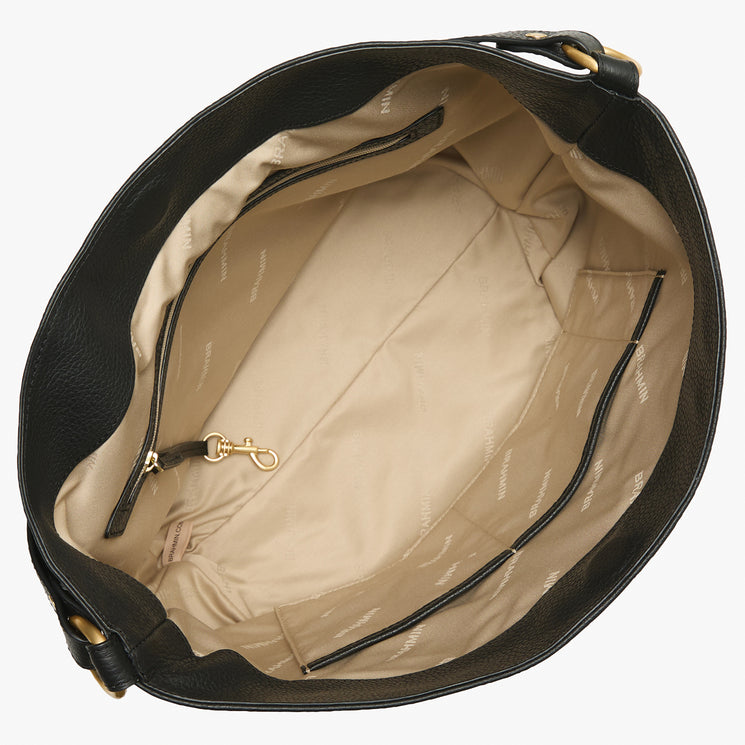 Brahmin black handbag with structured top view, beige fabric lining, interior slip and zip pockets, gold-tone key clip, subtle logo print, and dual handles. Bag is empty and open to reveal organized compartments.