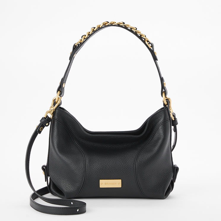 Brahmin black handbag with gold chain and hardware, structured top handle, adjustable crossbody strap, smooth texture, classic silhouette, shown against a white background.