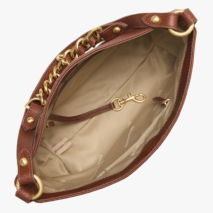 Brahmin brown handbag with gold chain and hardware, shown open to display a beige fabric-lined interior with multiple pockets and key clip; structured silhouette and visible Brahmin branding.