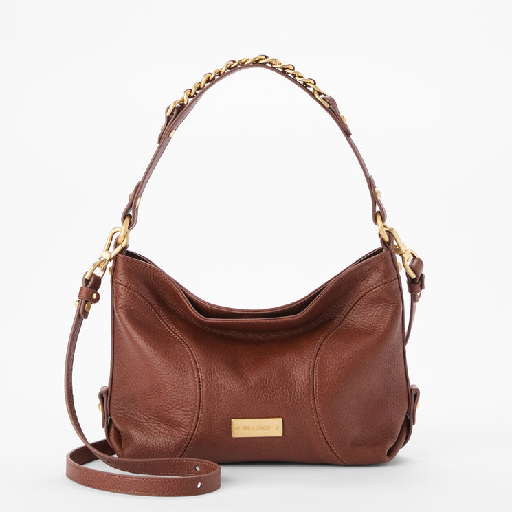 Brahmin brown shoulder bag with gold chain handle, detachable strap, and gold nameplate on the front; smooth texture, rectangular shape, displayed against a white background—ideal for hands-free wear.