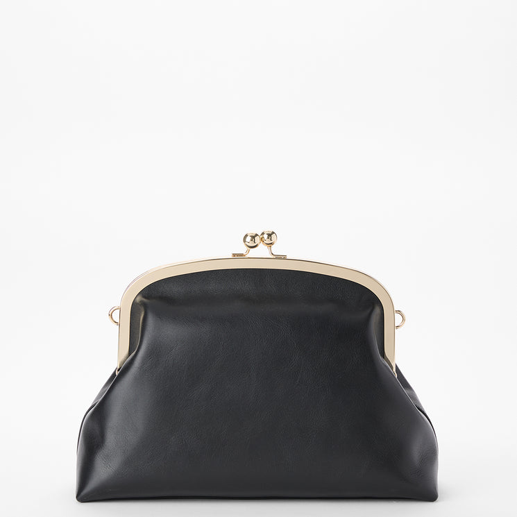 Brahmin structured black handbag with gold metal frame and clasp, vintage-inspired silhouette, smooth texture, top-handle strap, shown on a plain white background. No interior or branding visible.