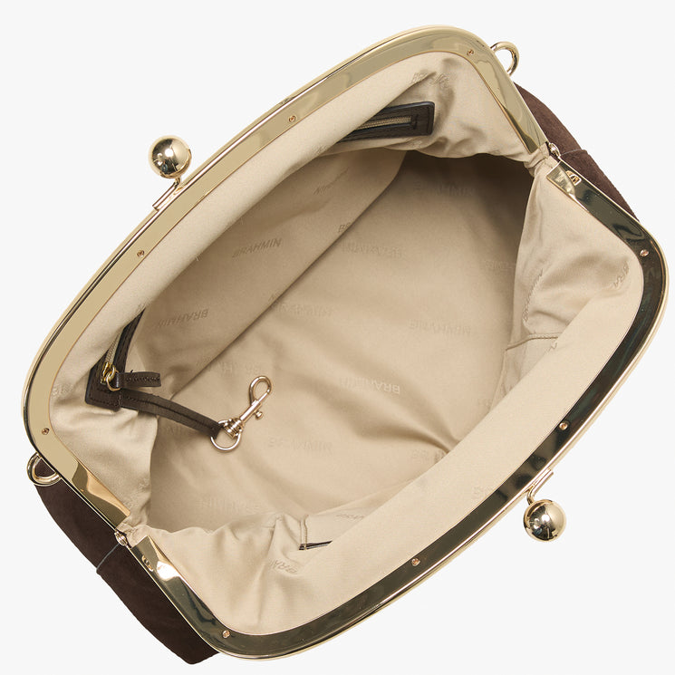 An open handbag shown from above, featuring a cream-colored interior lining, dark brown exterior edges, and a polished gold-tone metal frame with decorative ball hardware.