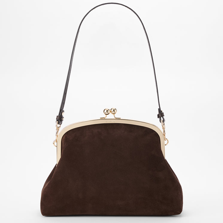 A dark brown suede kiss-lock handbag with a brown shoulder strap and gold-tone metal hardware, shown against a plain white background.