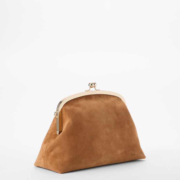 A tan suede kiss-lock clutch bag with a gold-tone metal frame and clasp, photographed on a seamless white background.