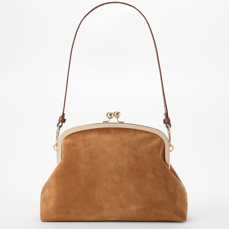 A tan suede kiss-lock handbag with a brown shoulder strap and gold-tone metal hardware, shown against a plain white background.