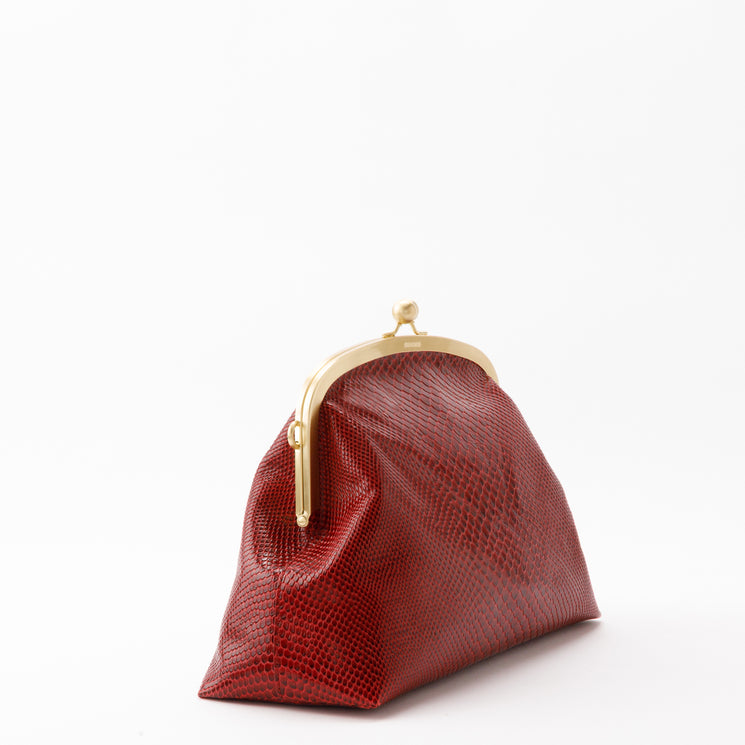 Brahmin Large Christine clutch in deep red with an embossed reptilian-inspired pattern, gold-tone frame, and kiss-lock closure.