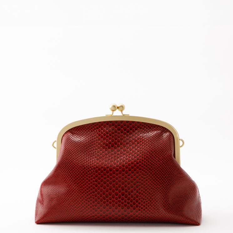 Brahmin Large Christine clutch in deep red with an embossed, scale-like texture, featuring a gold-tone metal frame and a kiss-lock closure.