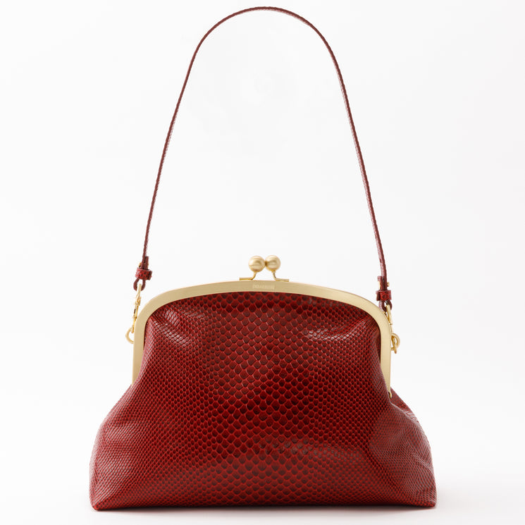 Brahmin Large Christine oversized clutch in deep red textured finish, featuring a gold-tone kiss-lock frame closure and a slim adjustable shoulder strap.