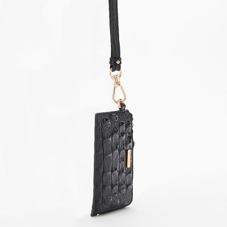 A black croc-embossed leather crossbody pouch with a long black strap and gold-tone hardware, shown against a plain white background. Side view.