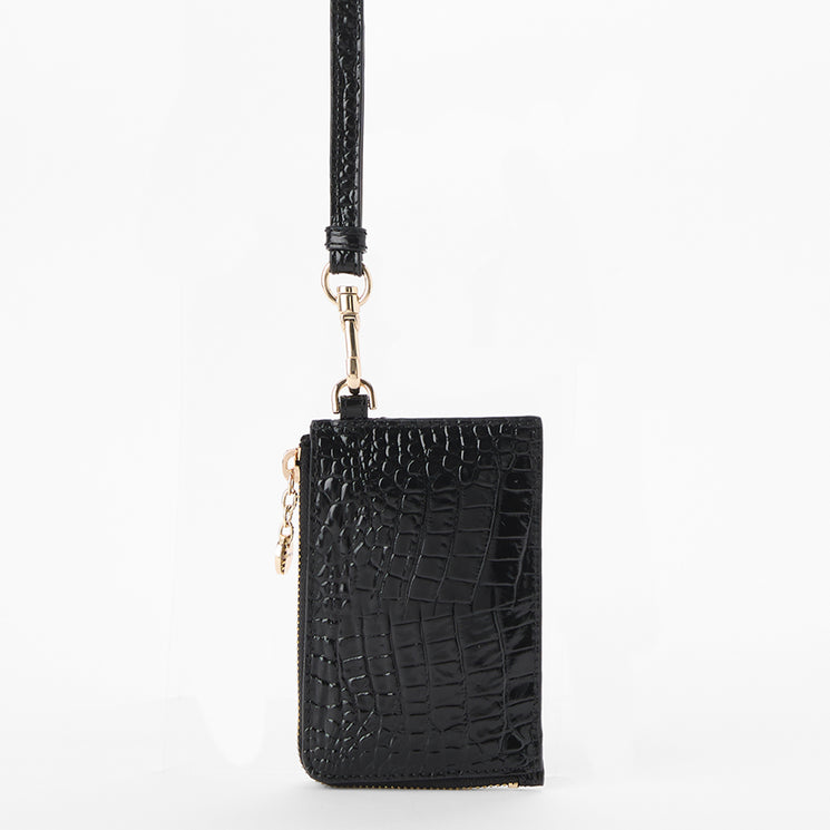 A black croc-embossed leather crossbody pouch with a long black strap and gold-tone hardware, shown against a plain white background. Back view.
