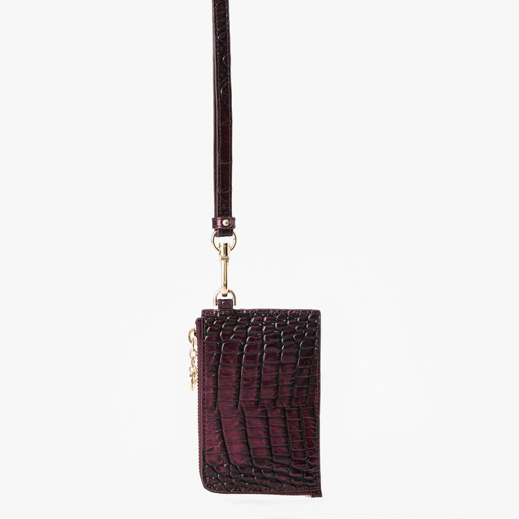 A dark burgundy crocodile-embossed leather crossbody phone pouch with a gold-tone clasp and strap, shown against a plain white background.