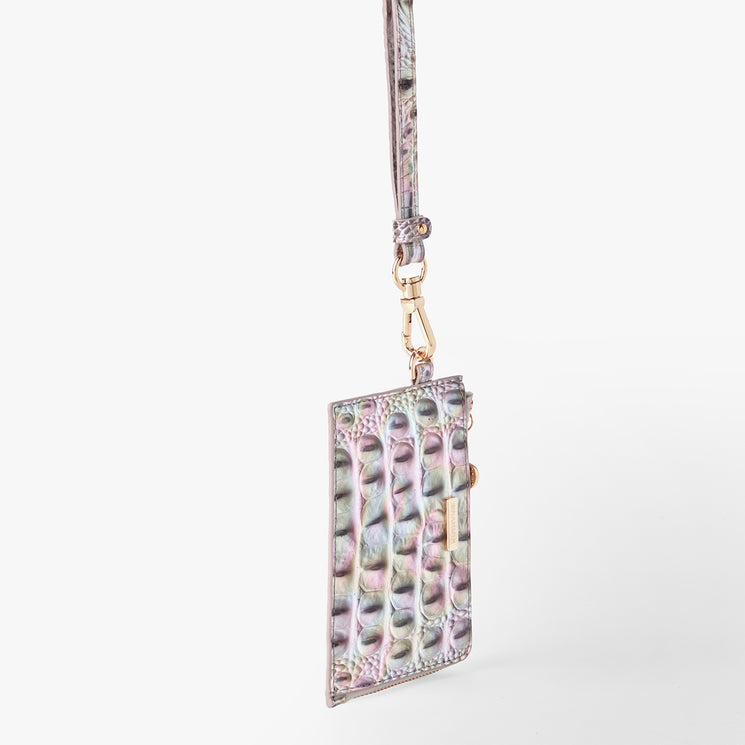 Brahmin iridescent cardholder with embossed crocodile-inspired pattern, gold-tone clasp, detachable wrist strap, and slim silhouette, shown on a plain white background.