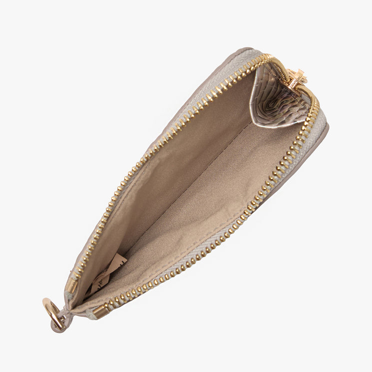 Brahmin beige zippered coin purse with gold-tone hardware, top view, featuring an empty main compartment and a small inner pocket on one side. Classic silhouette with smooth texture and elegant finish.