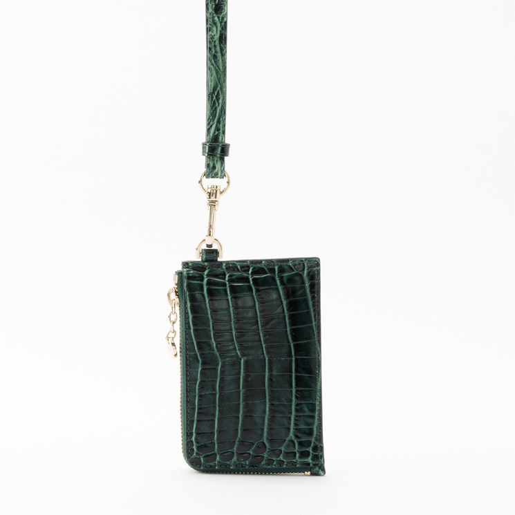 Brahmin Esther card holder in dark green with an embossed texture, featuring a detachable wrist strap and gold-tone hardware.
