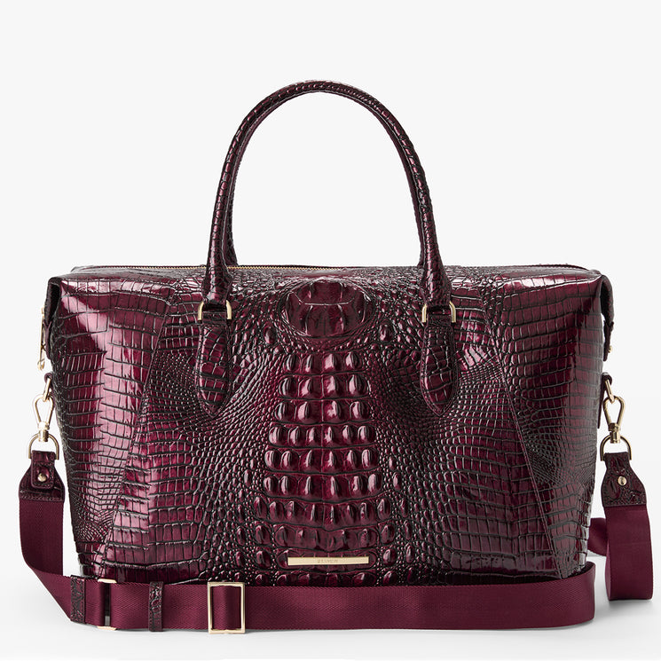 A glossy burgundy crocodile-embossed leather satchel bag with dual top handles, a matching detachable shoulder strap, and gold-tone hardware, shown against a plain white background.