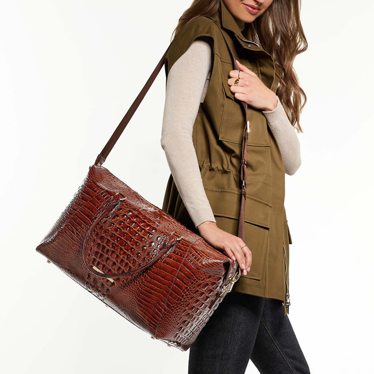 Woman wearing Daniela travel bag with a white background