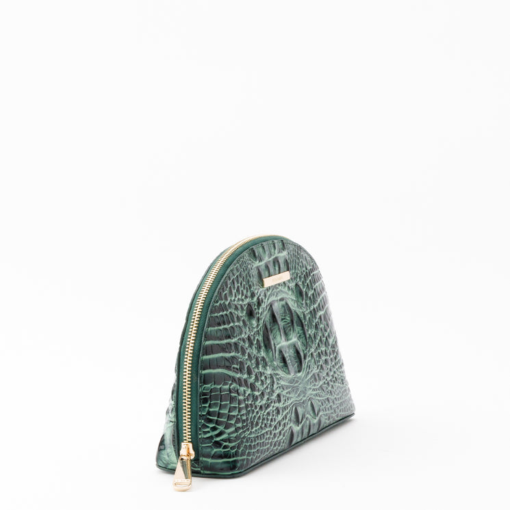 Brahmin Marna cosmetic bag in dark green with an embossed, croc-textured finish, featuring a dome-shaped silhouette and gold-tone zipper closure.