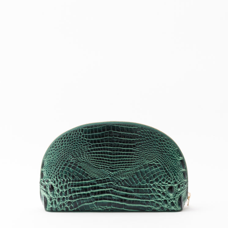 Brahmin Marna cosmetic bag in a half-moon silhouette featuring a dark green embossed texture.