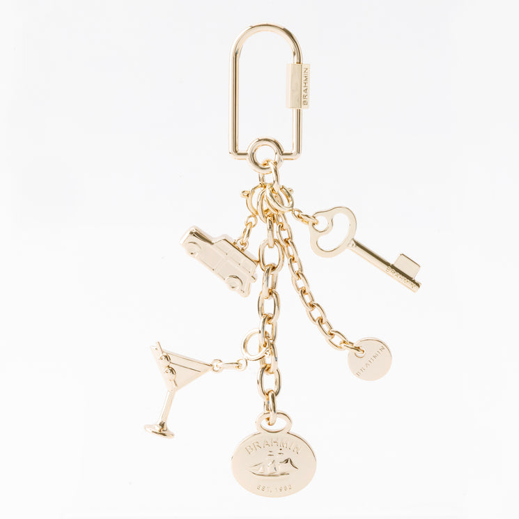 Gold-tone Small Martini keychain with a lobster clasp, featuring five charms including a car, martini glass, key, and two round discs engraved with the Brahmin brand name.