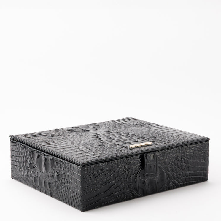 Large Box by Brahmin in black with a hinged lid, embossed textured finish, and a metallic logo plate on the front closure.