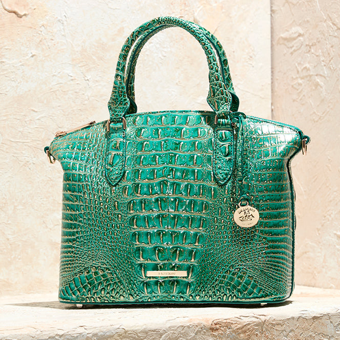 Brahmin emerald green croc embossed leather satchel handbag with rounded top handles, gold hardware, and signature medallion charm
