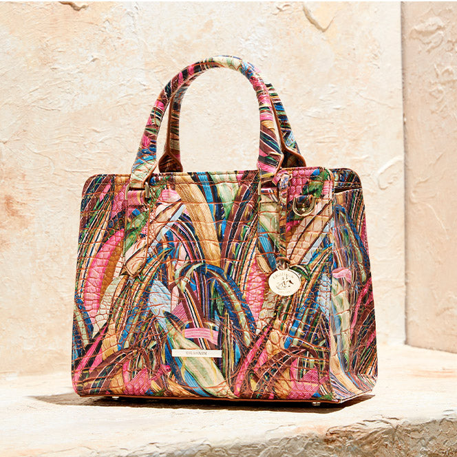 Colorful Brahmin satchel handbag with tropical multicolor print, structured handles, gold hardware, and signature croc embossed leather texture.