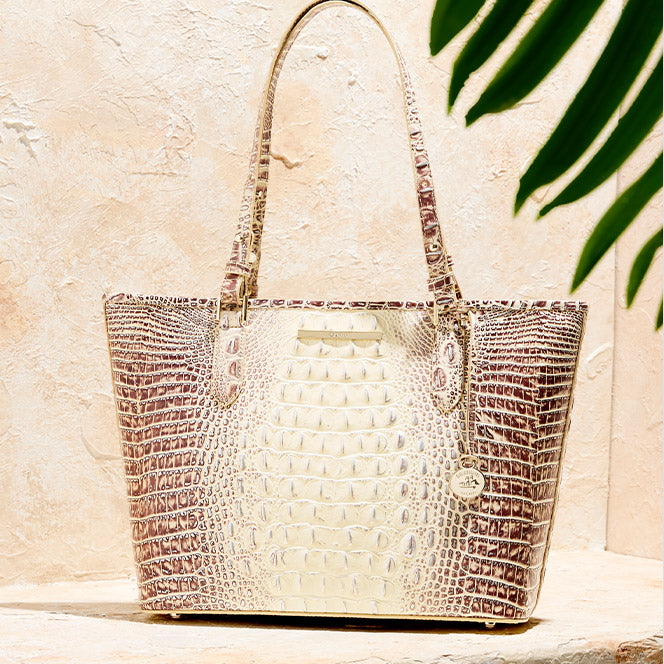 Cream and brown croc embossed Brahmin tote bag with long shoulder straps, gold hardware, and a structured silhouette.