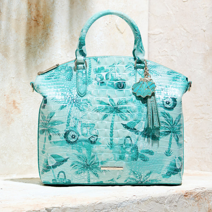 Turquoise Brahmin embossed leather satchel with tropical palm print, structured top handles, tassel charm, and silver logo plate.