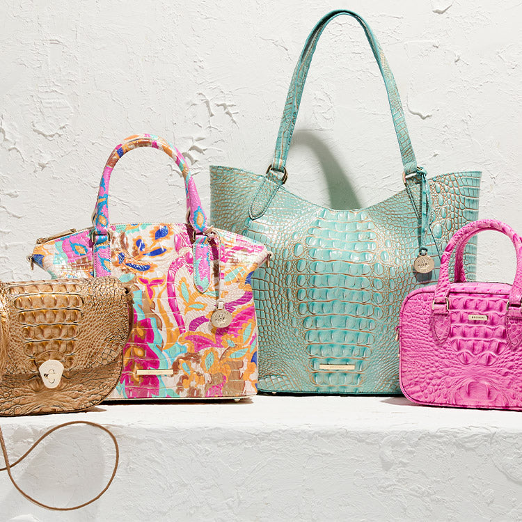 Collection of colorful handbags on a textured white background