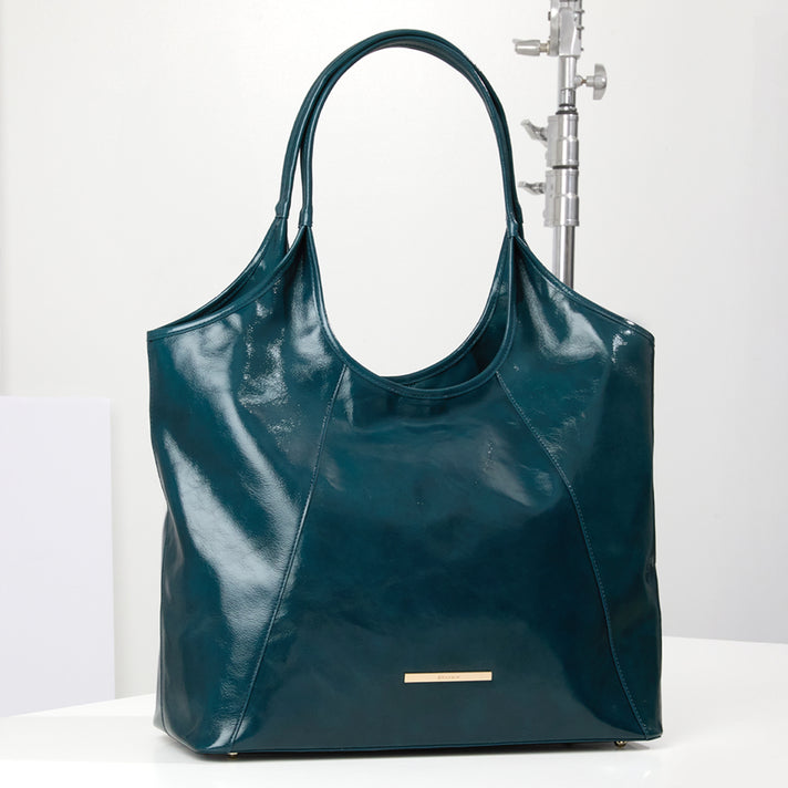 Brahmin teal designer tote bag with glossy finish, curved silhouette, double shoulder straps, contrast paneling and gold tone logo hardware.