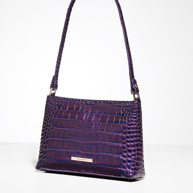 Small Brahmin shoulder bag in glossy purple croc-embossed leather, displayed against a white backdrop.