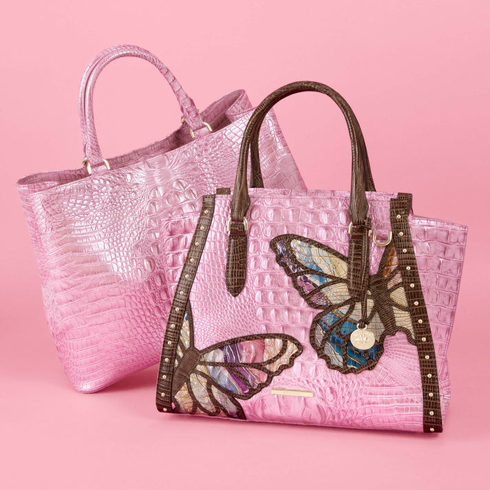 Brahmin pink tote bag collection featuring a large embossed tote and a butterfly embellished tote with brown trim, double handles, gold tone hardware and multicolor wing details.