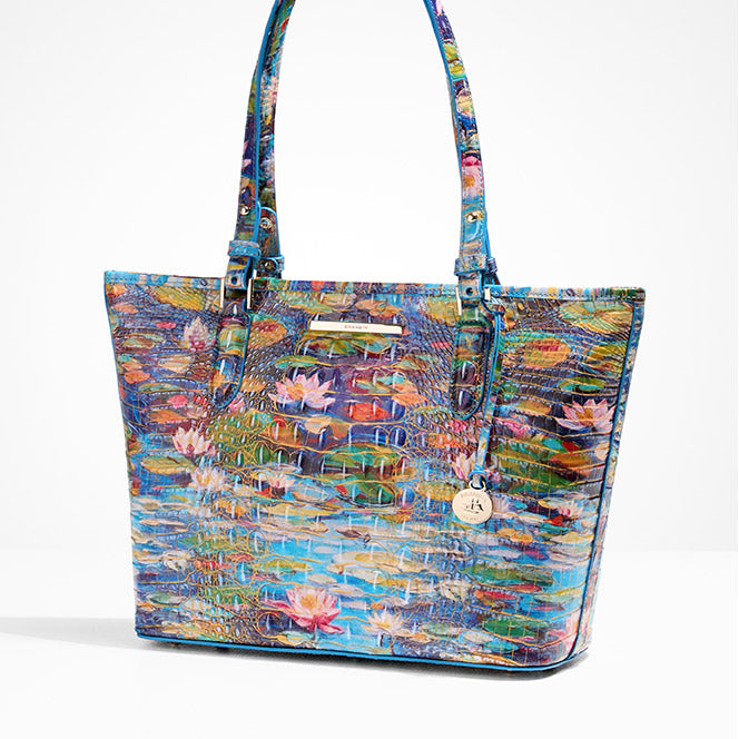 Multicolor water-lily artwork croc-embossed leather tote with long shoulder straps, gold-tone nameplate, and signature round hangtag