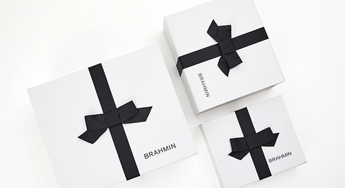 Luxury Brahmin branded boxes with black ribbon, premium gift wrapping for purses and leather goods.