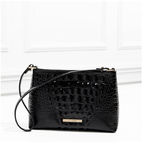 Black patent croc-embossed leather crossbody bag with zip-top closure, adjustable strap, gold-tone hardware, and front logo nameplate