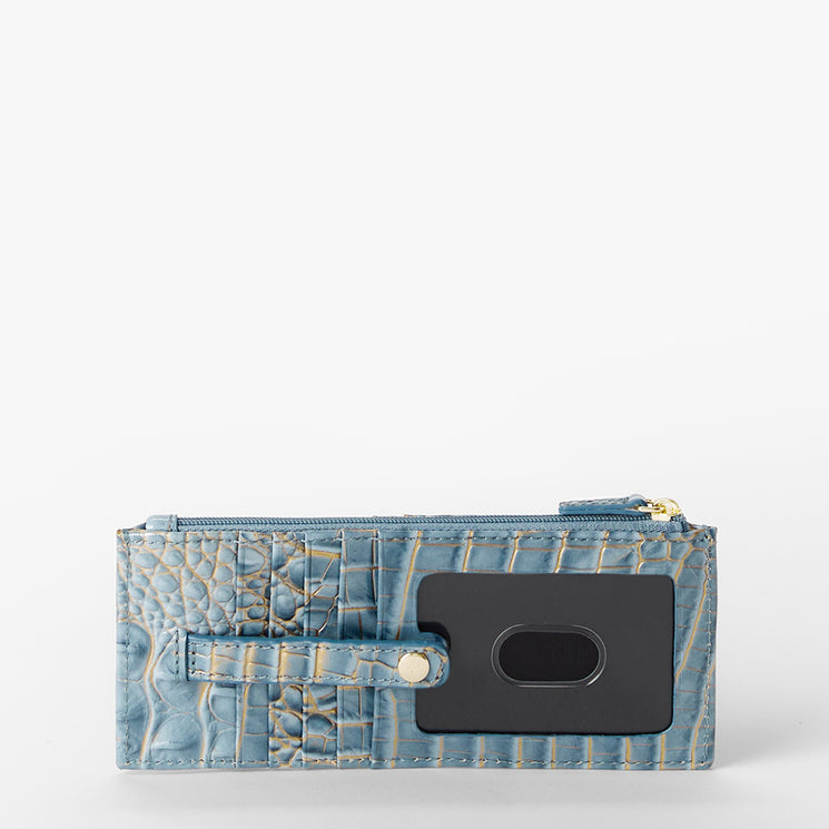 A light blue crocodile zip wallet with a black cardholder insert and gold-tone hardware, photographed on a clean white background.