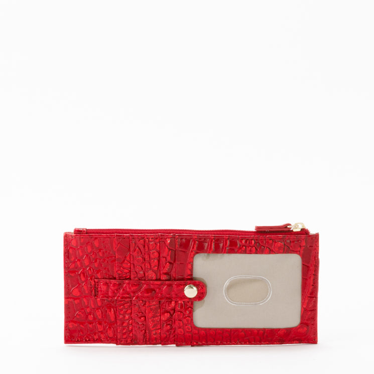 Brahmin red wallet featuring an embossed textured pattern, top zipper, multiple credit card slots, and a clear ID window secured by a snap-button strap.