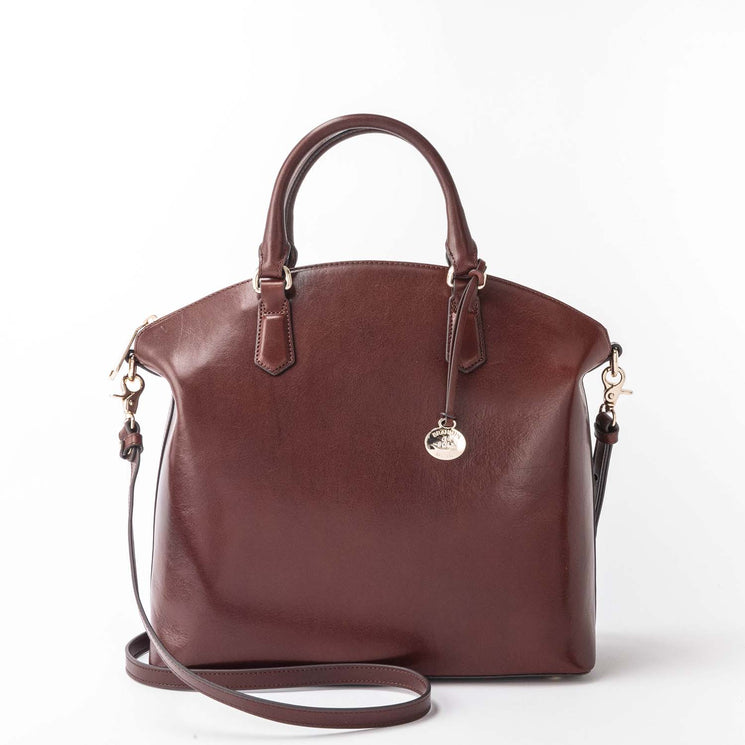 BRAHMIN Large Duxbury Satchel in brown with textured finish, structured silhouette, dual top handles, a detachable shoulder strap, gold-tone hardware and charm. Bag is displayed upright against a white background.
