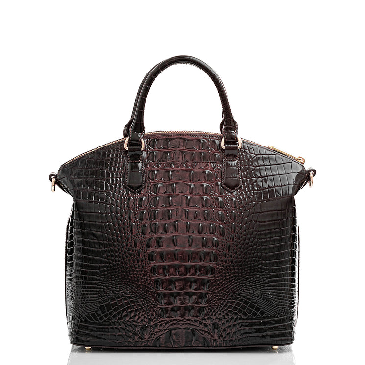 Brahmin black embossed handbag with gold hardware, two top handles, and structured silhouette, textured pattern, shown on a white background. Elegant design for hand or arm carry; no interior visible.
