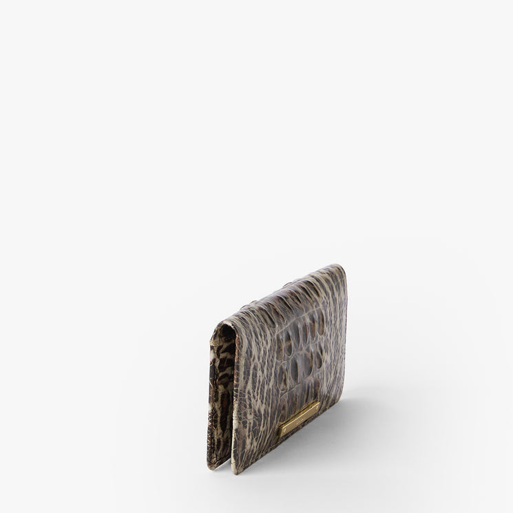 Leopard print wallet with a gold clasp on a white background. Ady Wallet side view.