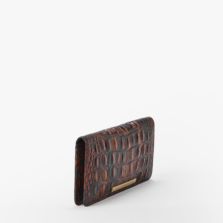 A dark brown textured leather wallet with an alligator or crocodile pattern and a small gold-tone metal accent, shown on a plain white background.