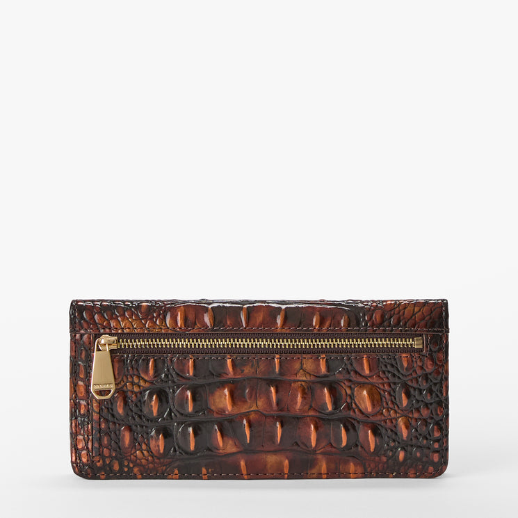 A brown crocodile-embossed leather clutch wallet with a gold-tone zipper and pull tab, shown against a plain white background.