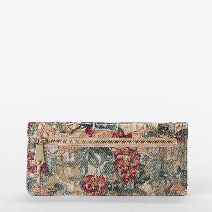 A rectangular zip-around wallet featuring a vintage floral tapestry pattern in muted red, green, and beige tones, with a gold-tone zipper and pull tab, set against a plain white background.