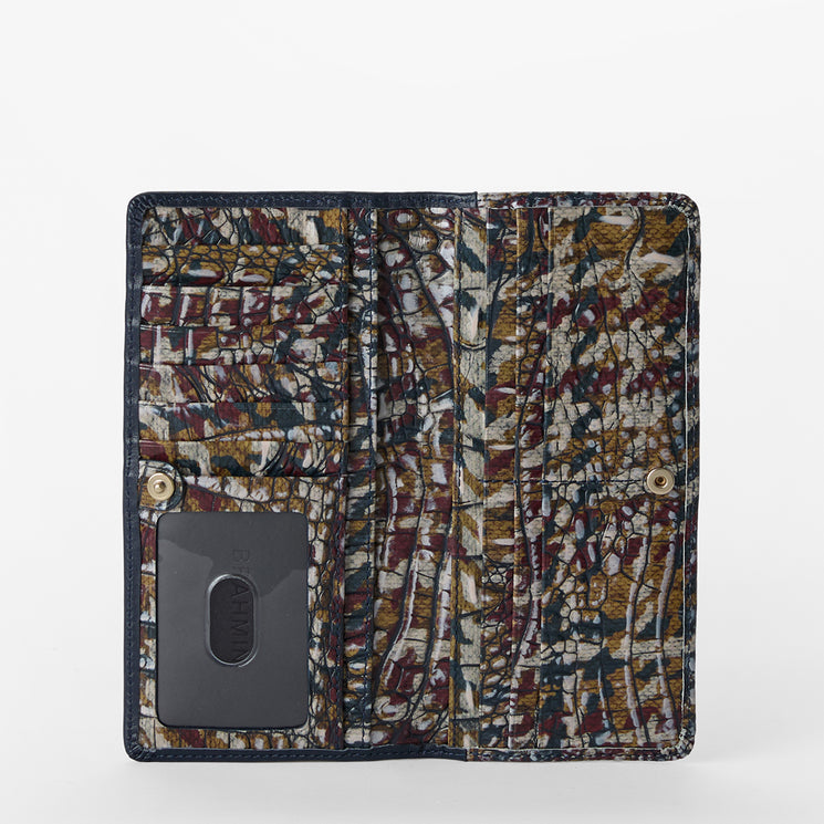 Multicolored patterned Ady wallet with brown leather accents on a white background. Open view.