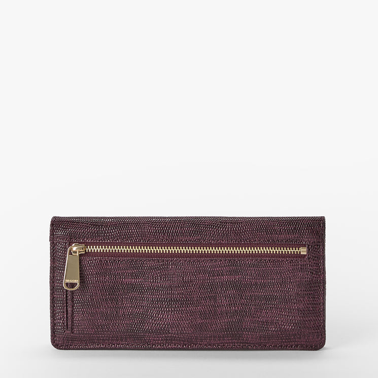 A textured leather clutch wallet in a deep plum purple with a gold zipper, shown against a plain white background.