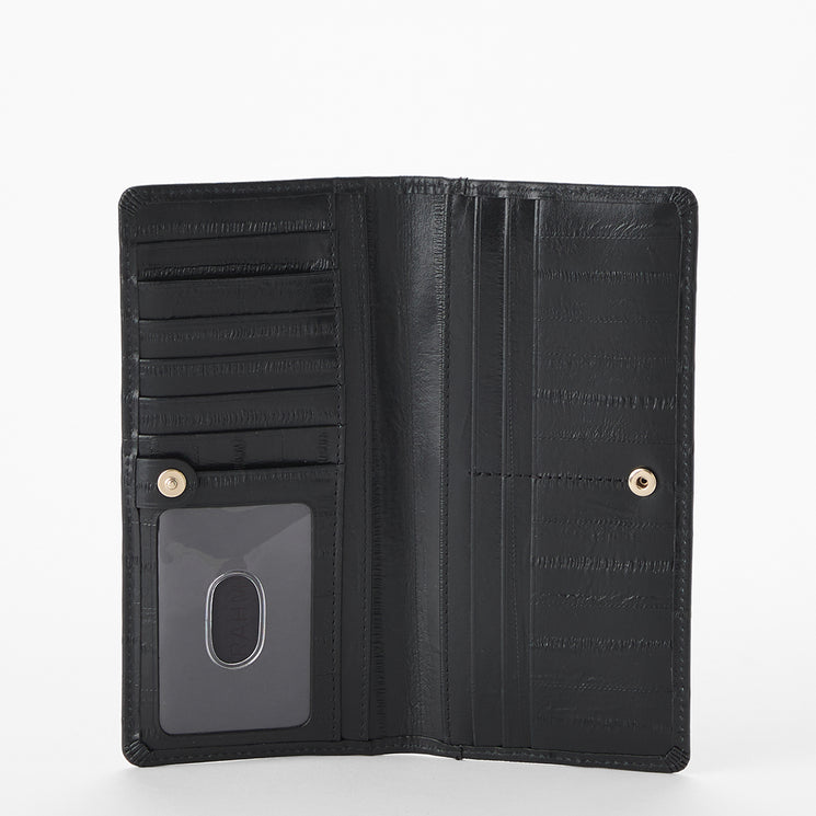 Brahmin black textured leather wallet open on white background, featuring card slots, a clear ID window, multiple vertical compartments, distinct embossed finish, and dual snap button closure.