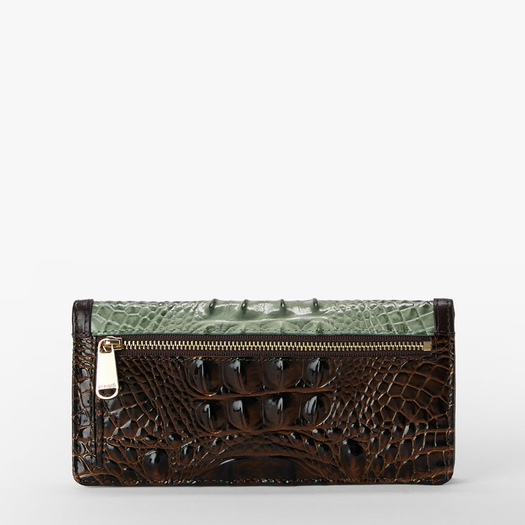 A rectangular clutch wallet featuring a dark brown crocodile-embossed front panel and a light green crocodile-embossed top flap, finished with a gold-tone zipper and pull tab, set against a plain light gray background.